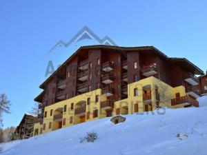 a large building on top of a snow covered hill at Appartement Bellentre, 2 pièces, 5 personnes - FR-1-329-23 in Bellentre