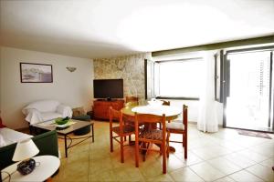 a living room with a table and a couch at Holiday house Ljubica Tisno in Tisno