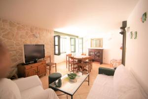 a living room with a couch and a table at Holiday house Ljubica Tisno in Tisno +26 photos