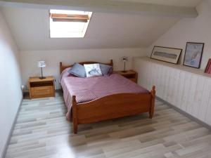 a bedroom with a bed and two night stands at Appartement LARUNS 2 à 4 personnes in Laruns