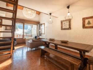 a living room with a wooden table and a couch at Appartement La Clusaz, 4 pièces, 8 personnes - FR-1-304-3 in La Clusaz