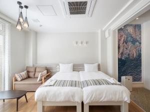 מיטה או מיטות בחדר ב-La Casa Panacea Okinawa Resort