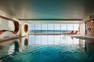 a swimming pool in a house with a view of the ocean at Cliff House Hotel in Ardmore