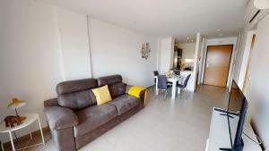 a living room with a brown couch and a table at Casa Francia - A Murcia Holiday Rentals Property in Roldán