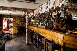a bar with a bunch of signs on the wall at Primrose Cottage in Kinnitty