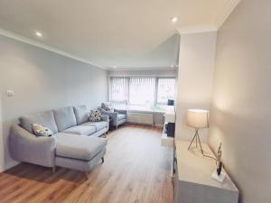 a living room with a couch and a chair at 21 Ivorhill in Stornoway