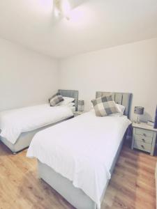 two beds sitting next to each other in a bedroom at 21 Ivorhill in Stornoway