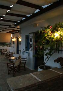 a restaurant with tables and chairs and a potted plant at Kionia Panorama Studios in Kionia