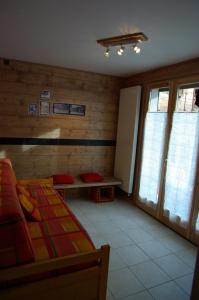 a bedroom with a bed and a bench and windows at Appart Ressachaux Morzine centre 2 à 3 pers calme vue jardin parking in Morzine