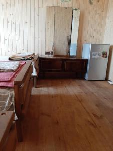 a room with a bed and a refrigerator in it at садиба ТУГАН-ДВІР in Svityazʼ