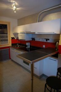 a kitchen with white cabinets and a table in it at Appart Ressachaux Morzine centre 2 à 3 pers calme vue jardin parking in Morzine
