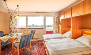 una camera d'albergo con letto, tavolo e finestra di Ferienwohnung Sonnenschein mit Pool a Wangerland