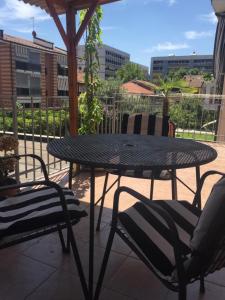 a patio table and chairs with a view of the city at Casa relax in Collegno
