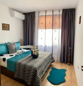 a bedroom with a bed and a table and a window at Byala Solita Apartament in Byala