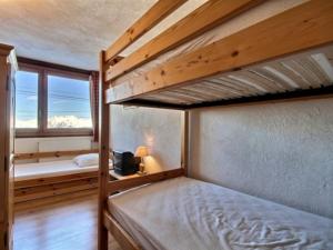 a bedroom with two bunk beds and a window at Appartement La Plagne, 3 pièces, 6 personnes - FR-1-455-57 in La Plagne