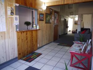 a hallway of a building with a counter and a table at Manowhenua Lodge in National Park