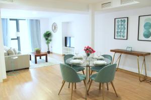 a dining room with a table and chairs in a living room at Apartments Ol&eacute; - Albareda 24 in Seville