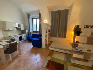 una camera con cucina e un soggiorno con tavolo di Appartamento Corte nel Grano a Rovereto