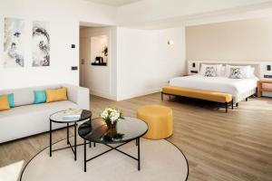 a hotel room with a bed and a couch at Arrecife Gran Hotel & Spa in Arrecife