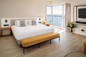 a bedroom with a large bed and a large window at Arrecife Gran Hotel & Spa in Arrecife