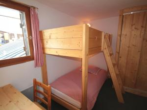 a bunk bed in a room with a table and a window at Appartement Les Saisies, 2 pièces, 4 personnes - FR-1-293-159 in Les Saisies