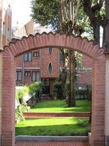 an archway in front of a brick house at eco Hotel Milano & BioRiso Restaurant in Milan