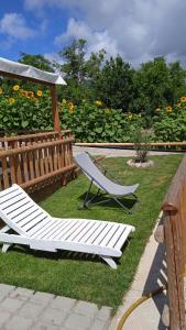 a white bench sitting on the grass in front of a garden at Astra in Agerola
