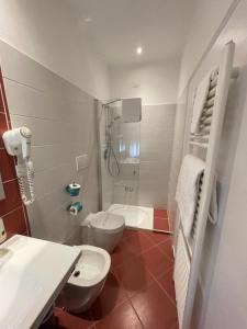 a bathroom with a toilet and a sink and a shower at Hotel San Marco in Reggio Emilia