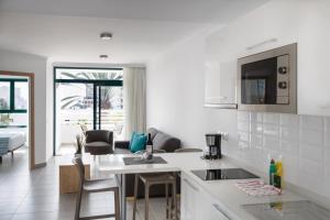 a white kitchen with a sink and a counter at Alsol Walhalla in Playa del Ingles