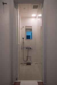 a bathroom with a shower with a toilet in it at ととのいVilla YAE in Motobu