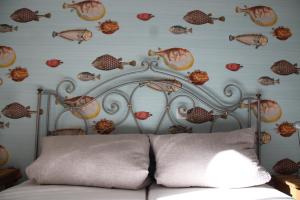 a bed with a metal headboard with fish on the wall at Strandbude16 in Timmendorfer Strand