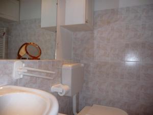 a bathroom with a white sink and a toilet at Studio Montgenèvre, 1 pièce, 4 personnes - FR-1-445-71 in Montgenèvre