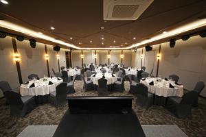 a banquet room with tables and chairs with white tablecloths at Layers Hotel Busan Hadan in Busan +41 photos