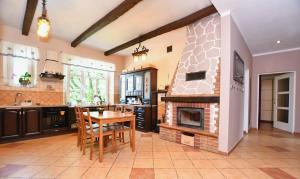 a kitchen with a table and a fireplace at Apartament Pablo 75m2 w centrum Tarnowskich Gór in Tarnowskie Góry