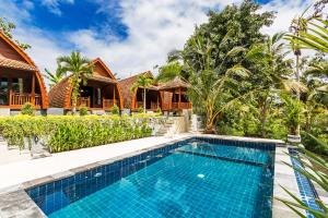 an image of a swimming pool in front of a house at Kelingking Mesari Villa and Spa in Nusa Penida