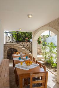 a dining room with tables and a stone fireplace at Pension Panorama in Kalamaki Heraklion