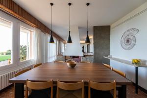 a dining room with a wooden table and chairs at Villa Can Bagués in Mataró