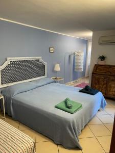 Un dormitorio con una cama grande con una toalla verde. en B&B Casa Avallone en Nápoles