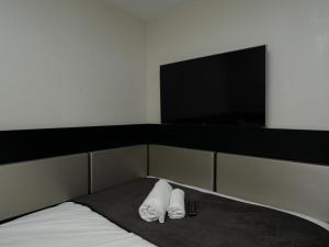 a bedroom with a bed with two white towels at Great St Helen Hotel in London