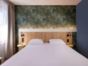Ein Bett oder Betten in einem Zimmer der Unterkunft ibis Brussels Waterloo