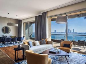 a living room with a couch and chairs and a table at Rixos The Palm Luxury Suite Collection - Ultra All Inclusive in Dubai