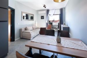 a living room with a table and a couch at Villa Mariella in Novalja