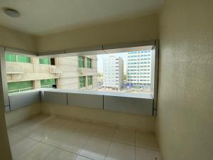 an empty room with a large window in a building at Phoenix Plaza Hotel Apartments in Abu Dhabi