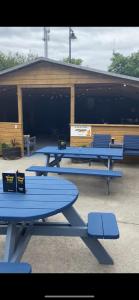 a group of blue picnic tables with surfboards on them at The Strand Guest House in Falcarragh