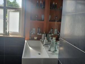a bathroom with a white sink and a window at Bexleyheath Midfield in Bexleyheath