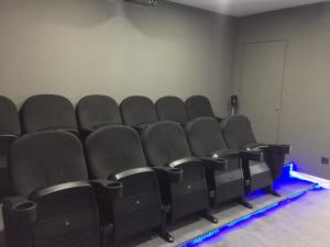an empty theater with black chairs in a room at Casa Pena in Barcelos +36 photos