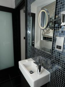 a bathroom with a sink and a mirror at Great St Helen Hotel in London