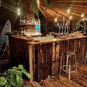 a wooden bar with a bar stool and wine glasses at Hotel Al Verde in Mandello del Lario