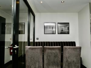 a group of chairs sitting in a room at Great St Helen Hotel in London