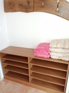 a closet with wooden shelves and towels at Slunečnice - Ubytování v soukromí na Třeboňsku in Třeboň
